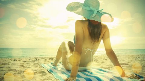 Young woman lying on the beach